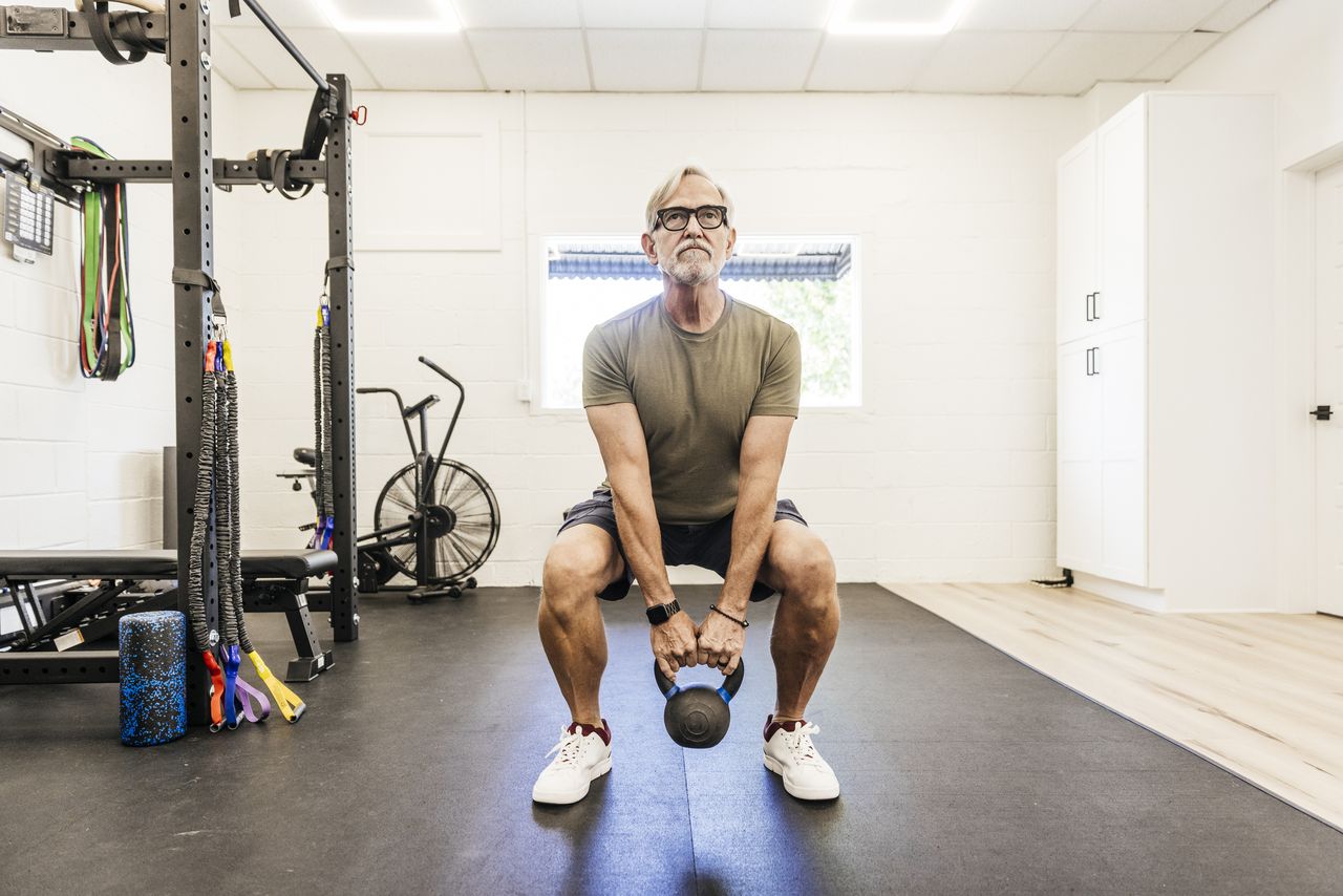 A man practicing resistance training with a kettle bell