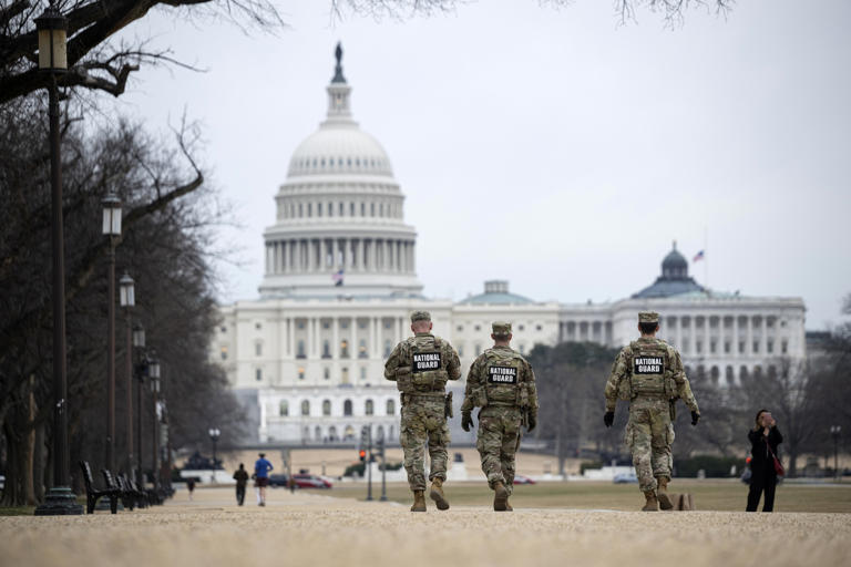 Celal Gunes/Anadolu via Getty Images - PHOTO: National Guard members walk along the National Mall in Washington D.C., Jan. 14, 2026.