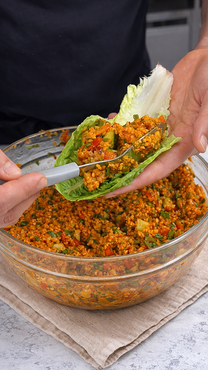 Making vegan bulgur salad with fresh herbs