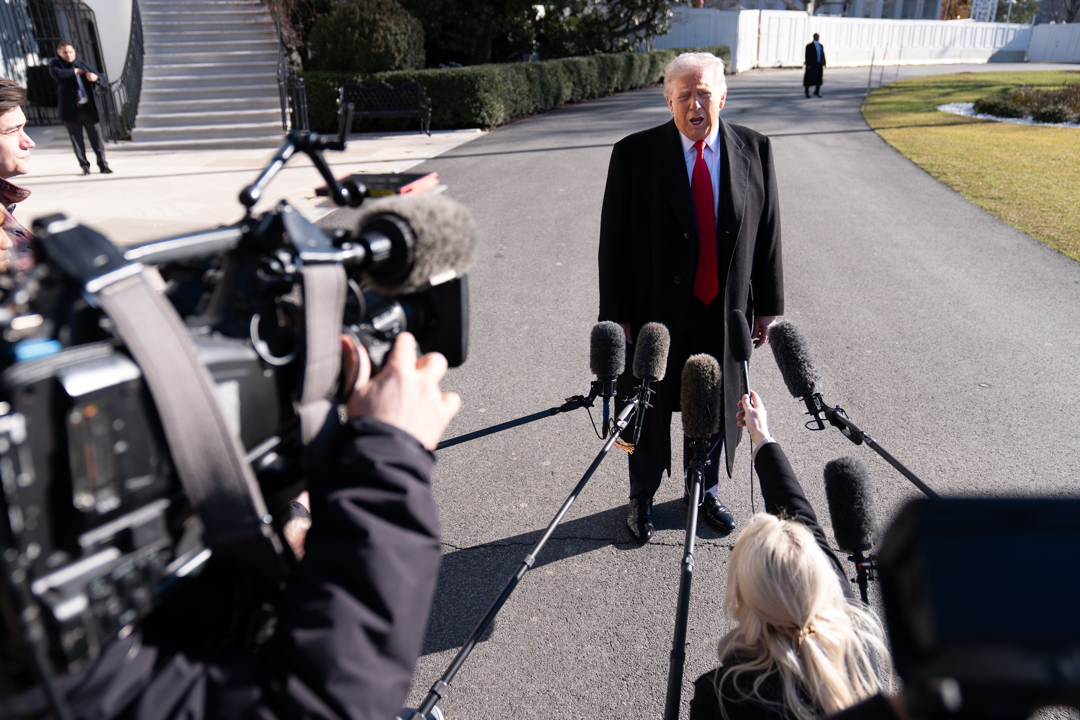 President Donald Trump speaks with the press Tuesday before boarding Marine One.