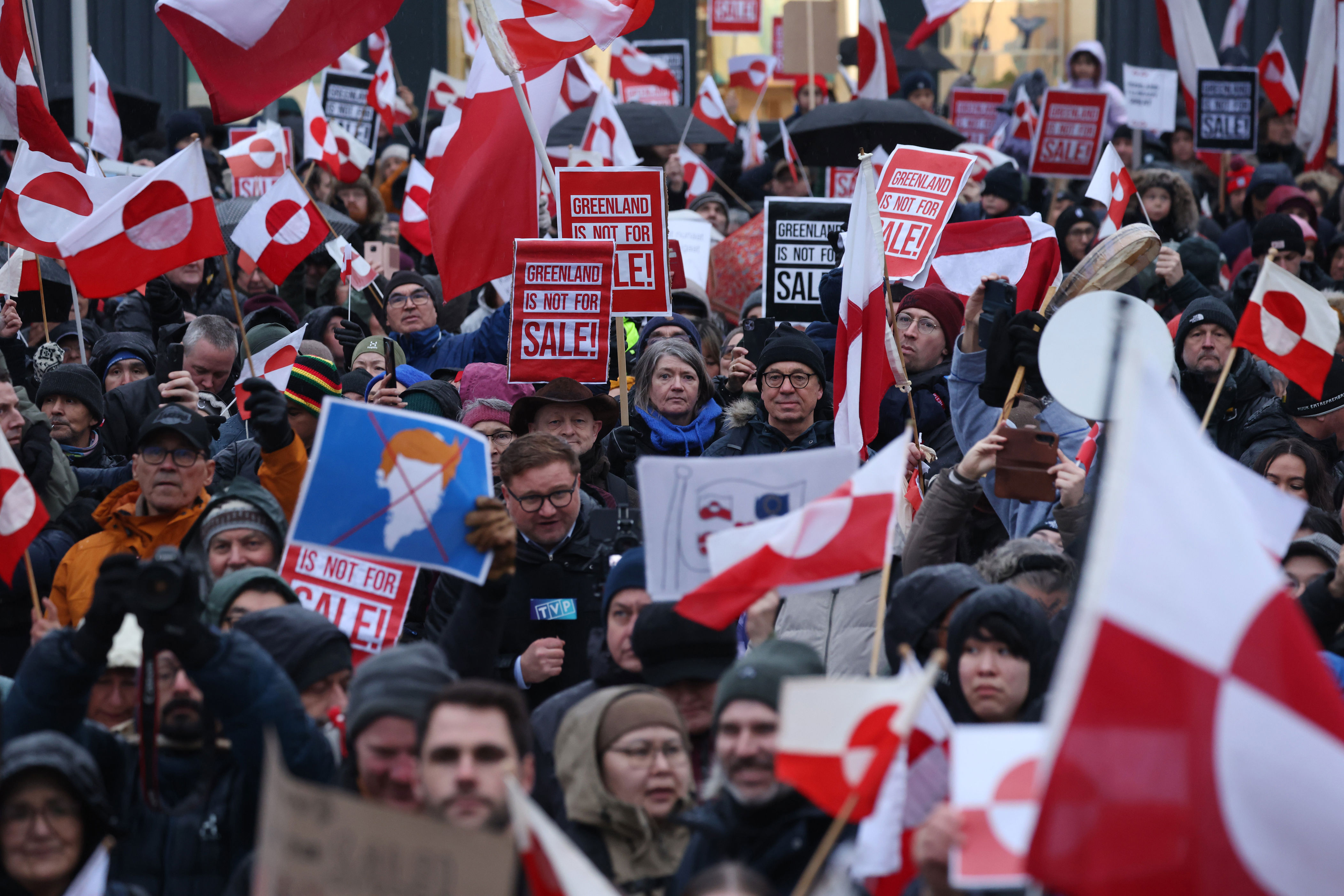 People bear Greenlandic flags as they march to protest against US president Donald Trump and his announced intent to acquire Greenland (Getty)