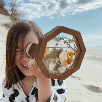 A child looking through the kaleidoscope