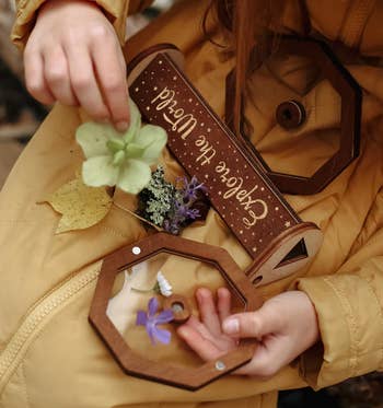 A child adding flowers inside the lid of the kaleidoscope