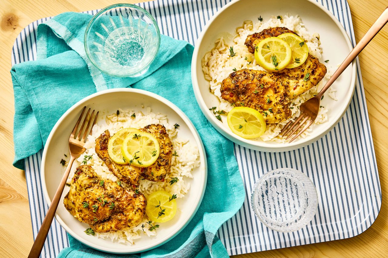 Slow Cooker Lemon Garlic Butter Chicken in bowls to serve over rice topped with lemon slices