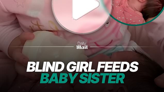 Blind girl gently feeds her baby sister