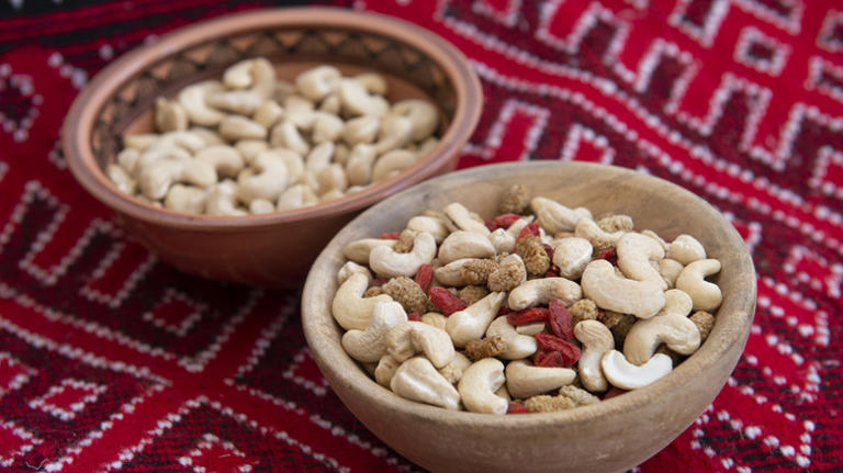 Ivory Coast cashews in wooden bowls on blanket