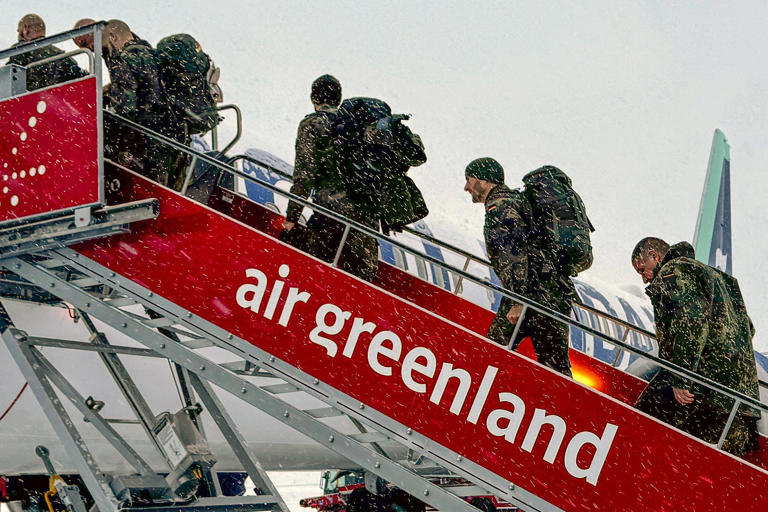 Military personnel from the German armed forces board a flight leaving Nuuk airport for Reykjavik on Sunday (AFP via Getty)