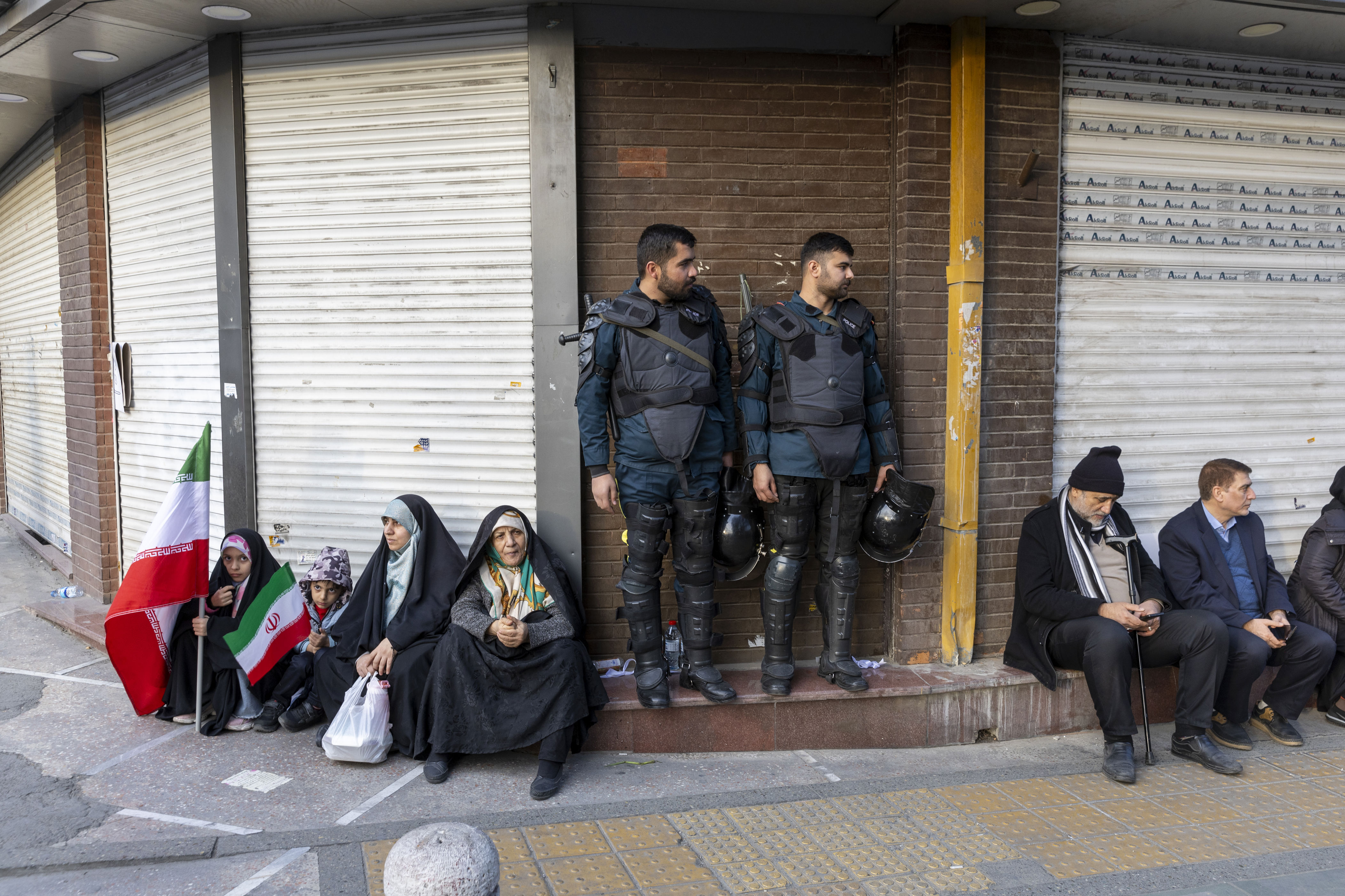 Members of Iran's security forces are seen on the sidelines of a pro-government rally in Tehran on Jan. 12.