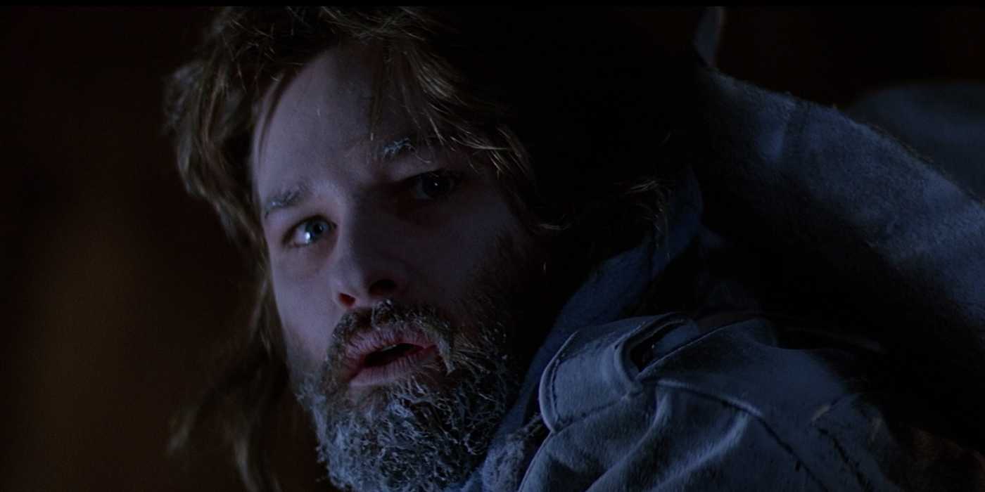 Mac with frost in his beard looks nervously over his shoulder in The Thing