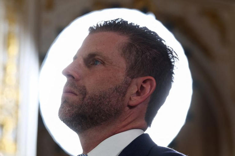 Eric Trump, Executive Vice President of The Trump Organization and son of U.S. President Donald Trump, listens to his father speak at a ceremony held to dedicate a 4-mile stretch of road from West Palm Beach Airport to President Trump's Mar-a-Lago estate as 'President Donald J. Trump Boulevard', at the Mar-a-Lago estate in Palm Beach, Florida, U.S., January 16, 2026. REUTERS/Kevin Lamarque