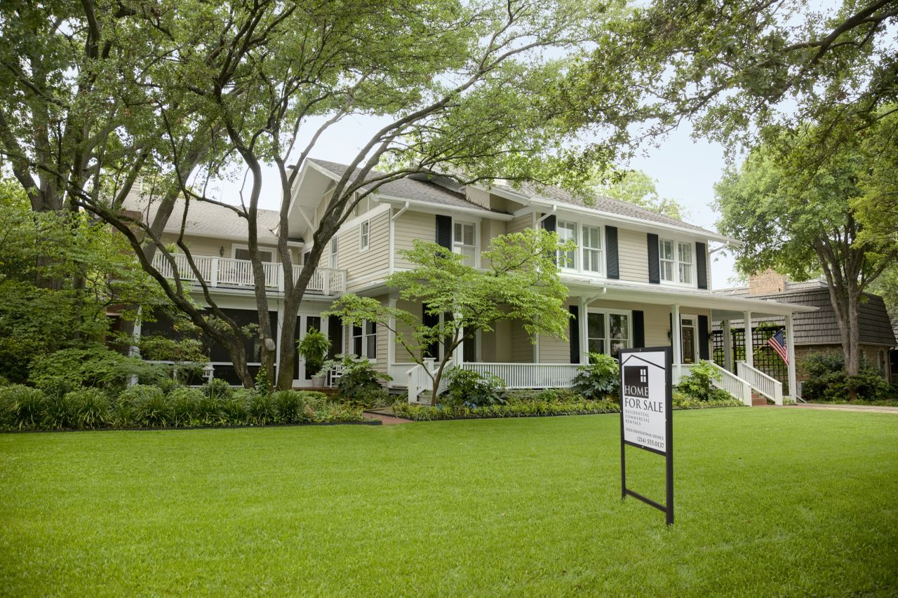 Residential Home Exterior with Sale Sign