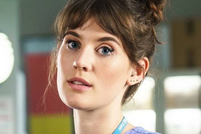 Anna Chell in a blue outfit in a promo photo for Casualty.
