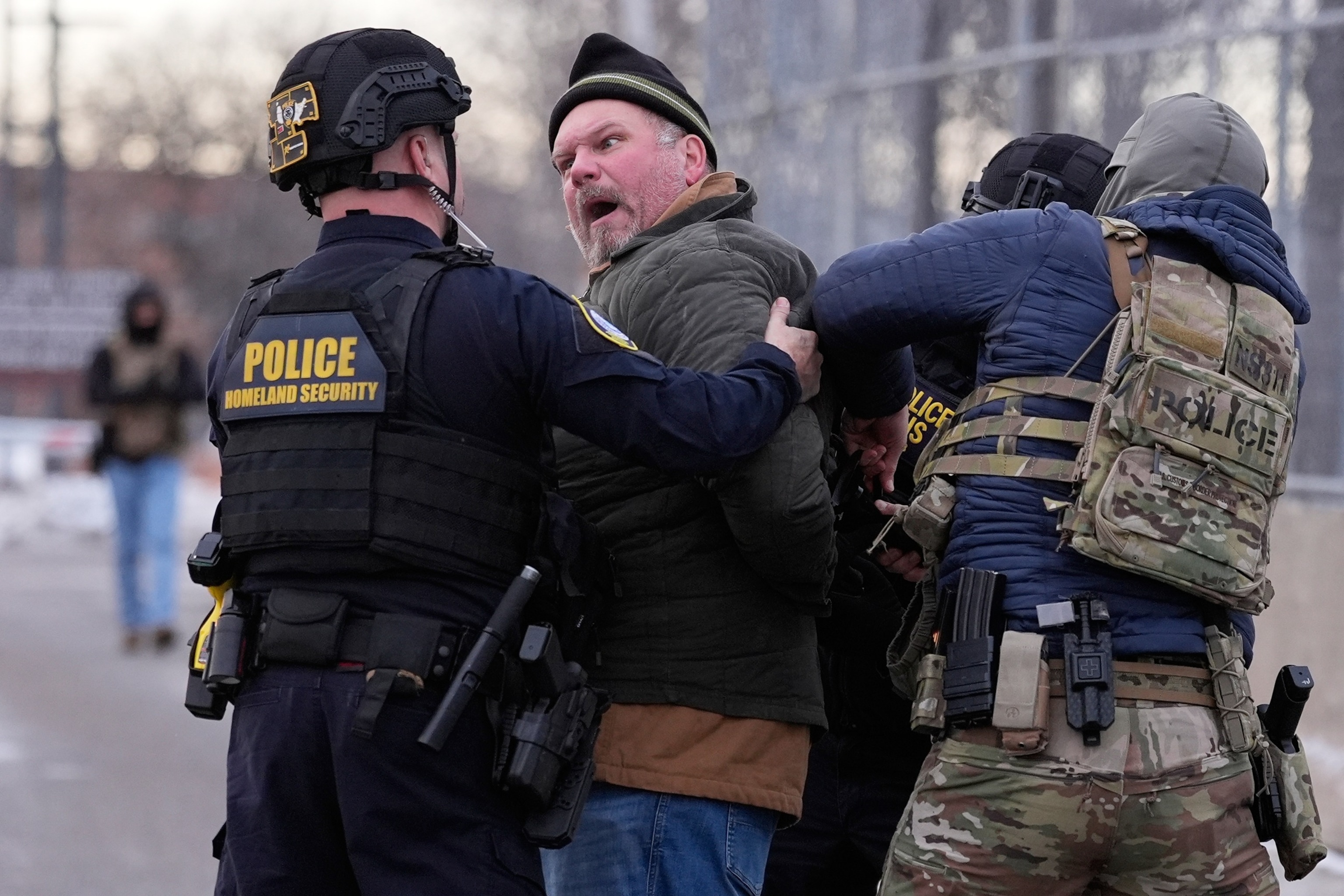 Yuki Iwamura/AP - PHOTO: Law enforcement detain a man outside the Bishop Henry Whipple Federal Building during a protest, Jan. 17, 2026, in Minneapolis.