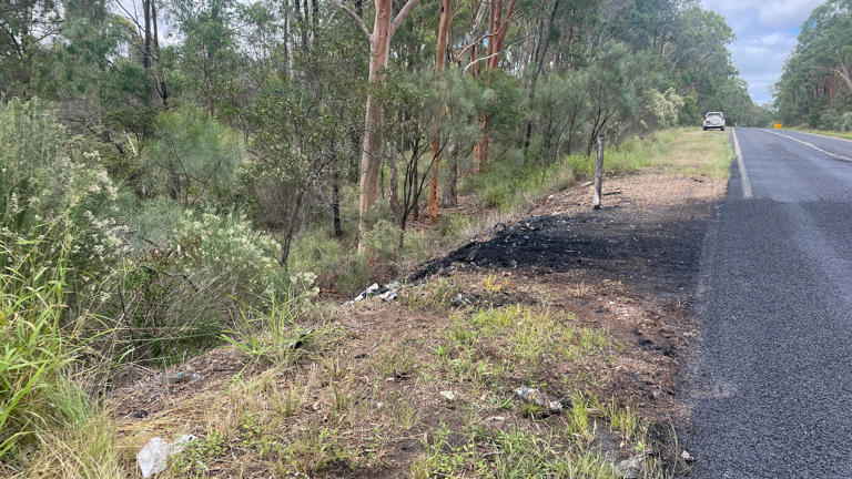 Debris lines the side of the Bunya Highway after a fatal crash. (ABC News: Aisling Brennan)