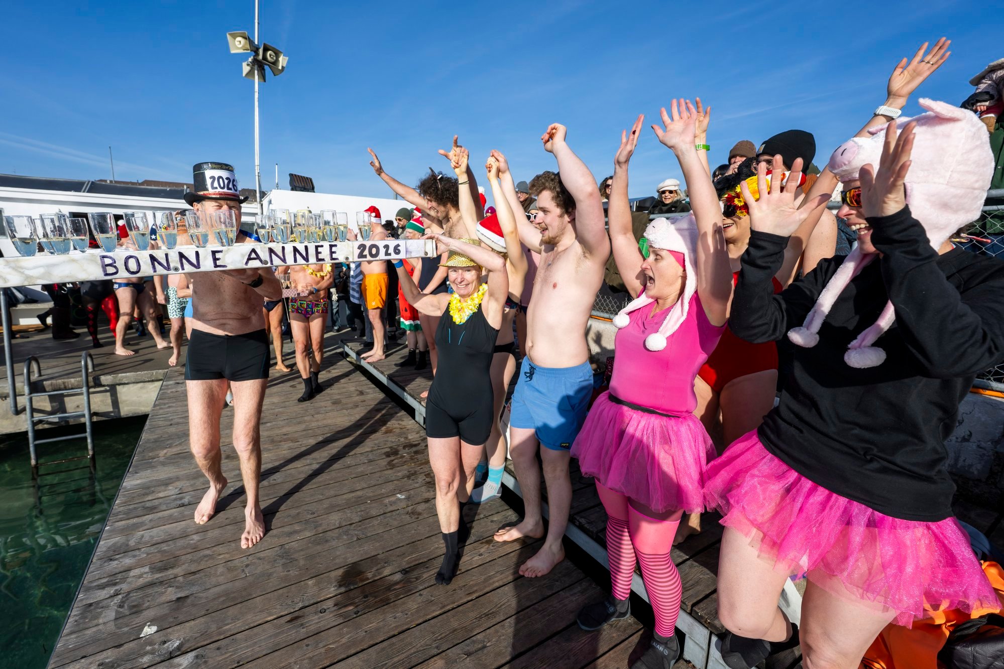 People in Geneva, Switzerland, celebrate the new year with champagne and the traditional swim in Lake Geneva on January 1. Achieving Switzerland-level living standards for all by 2100 will require a deliberate choice to build inclusive systems. Photo: EPA