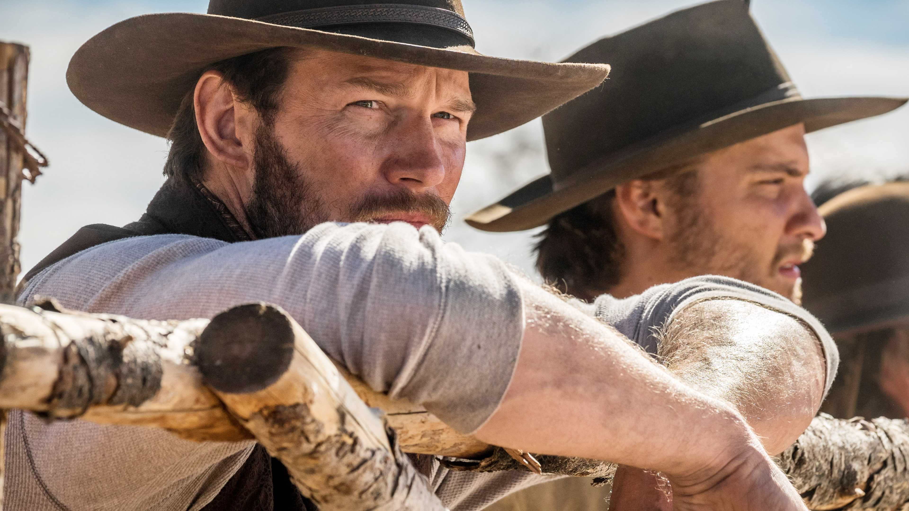 Chris Pratt and Luke Grimes staring ahead in a scene from The Magnificent Seven