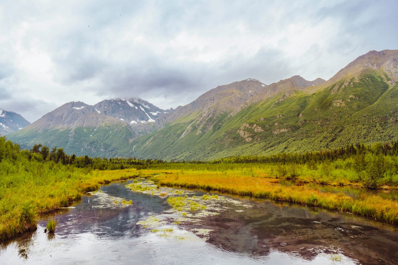a pond and mountains in Chugach state park