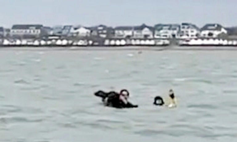 Two men rescued from rising tide minutes before being submerged