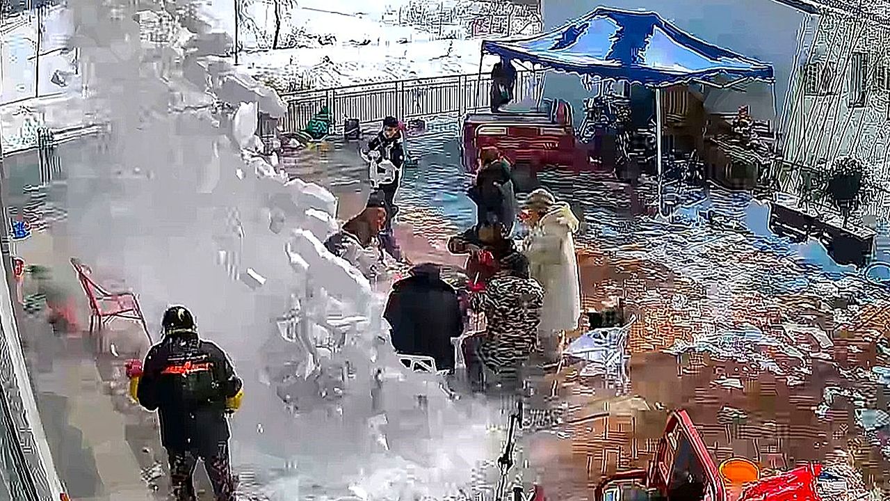 Big pile of snow falls from roof onto family having meal