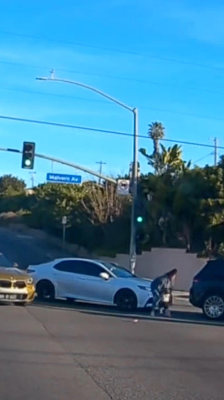 Heart-stopping moment toddler is nearly run over after falling from ...