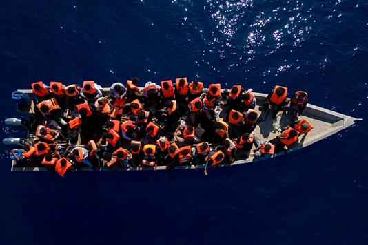 Migrants from Eritrea, Libya and Sudan sail in a wooden boat before being assisted by aid workers of the Spanish NGO Open Arms in the Mediterranean Sea, 17 June, 2023 AP Photo