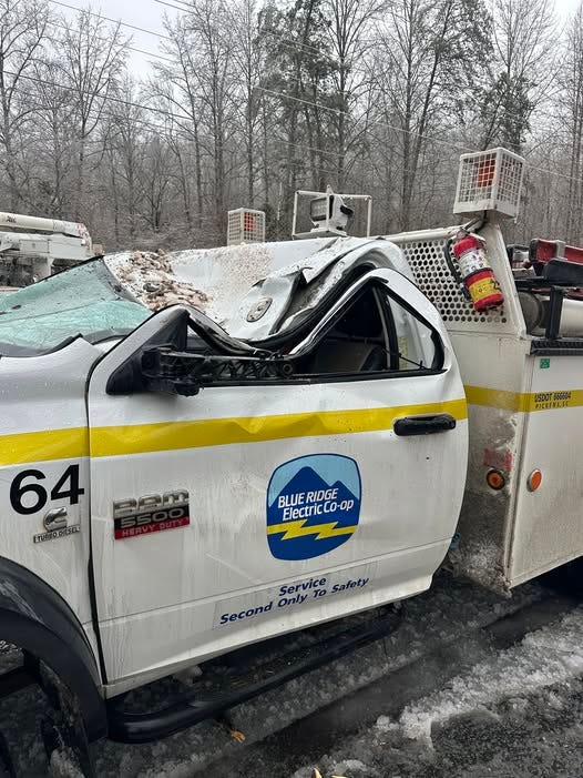Utility workers escape uninjured after tree falls on truck
