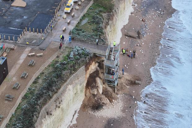 Cliff collapse sees families and dog trapped on beach