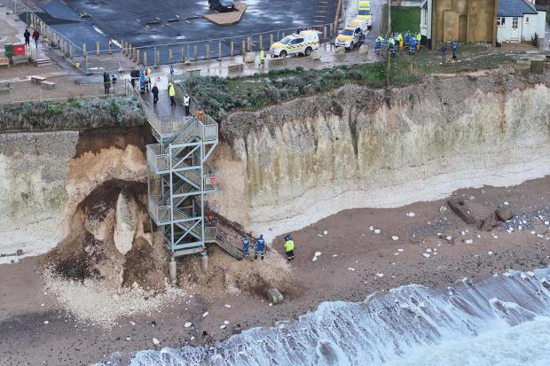 In pictures: Families and dog winched to safety after cliff collapses ...