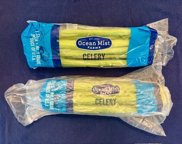 Two packages of Ocean Mist Farms celery on a surface still in plastic wrappings