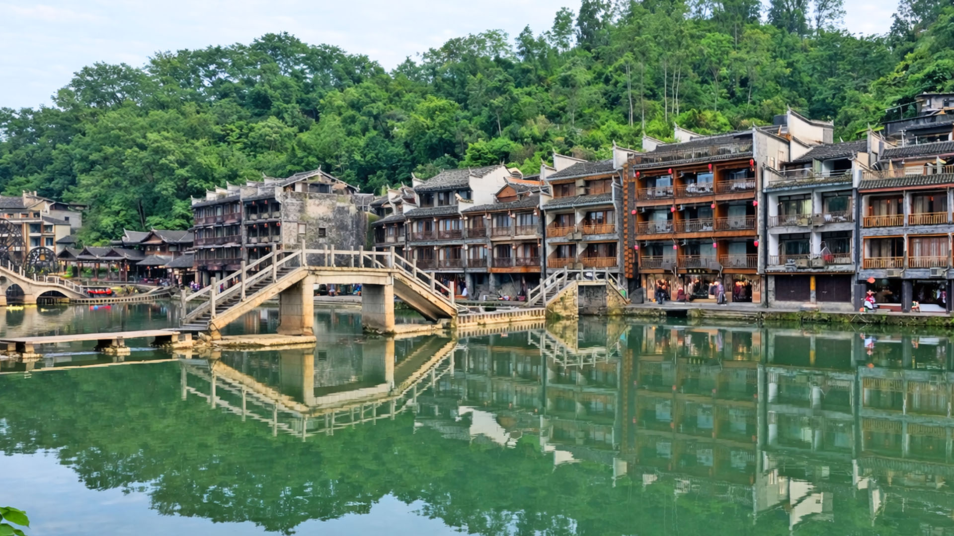 Stone bridge and riverside homes in China