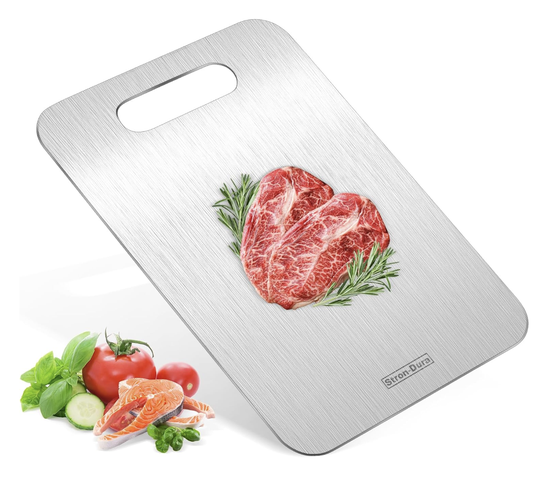 A stainless steel cutting board with a top handle featuring an image of raw meat and herbs and vegetables placed beside