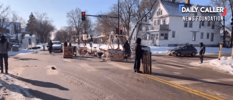 Police tear down anti-ICE road blockade after masked men assault reporter