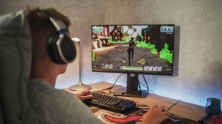 Person playing video games on desktop PC
