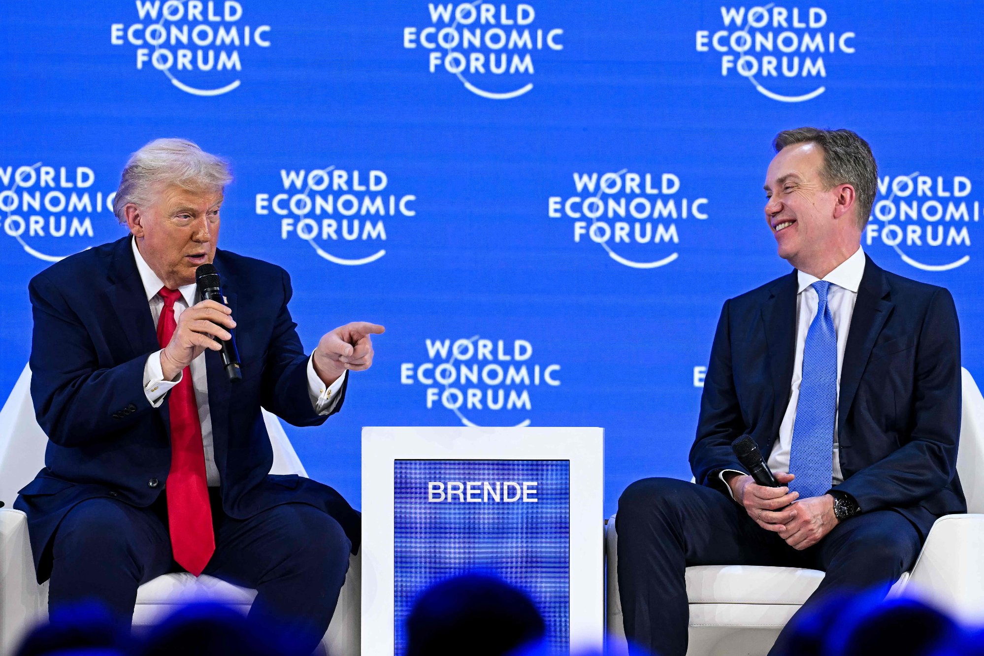US President Donald Trump (L) speaks with World Economic Forum president and CEO Borge Brende during the World Economic Forum (WEF) annual meeting in Davos on January 21, 2026. The World Economic Forum takes place in Davos from January 19 to January 23, 2026. (Photo by Fabrice COFFRINI / AFP)