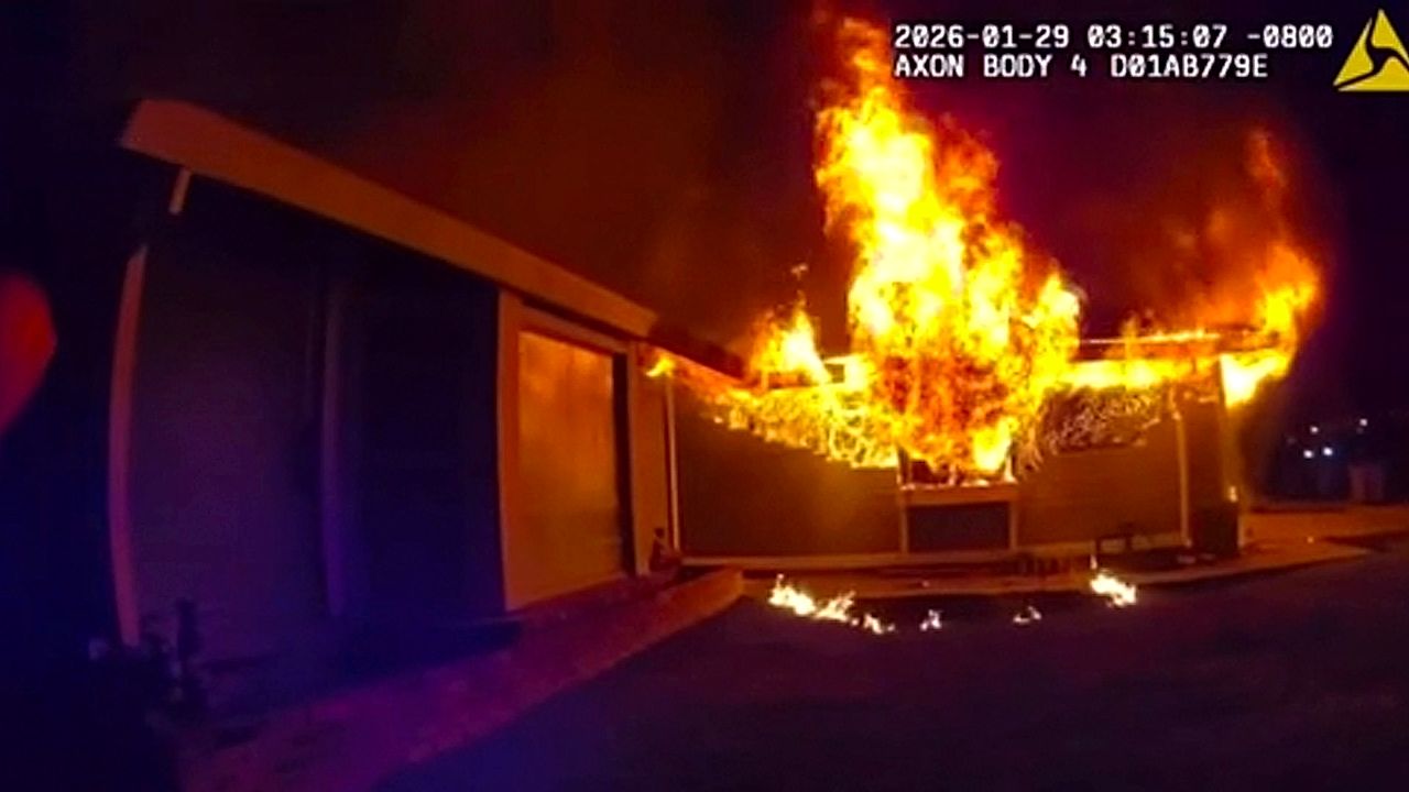 Police save woman from burning home in California