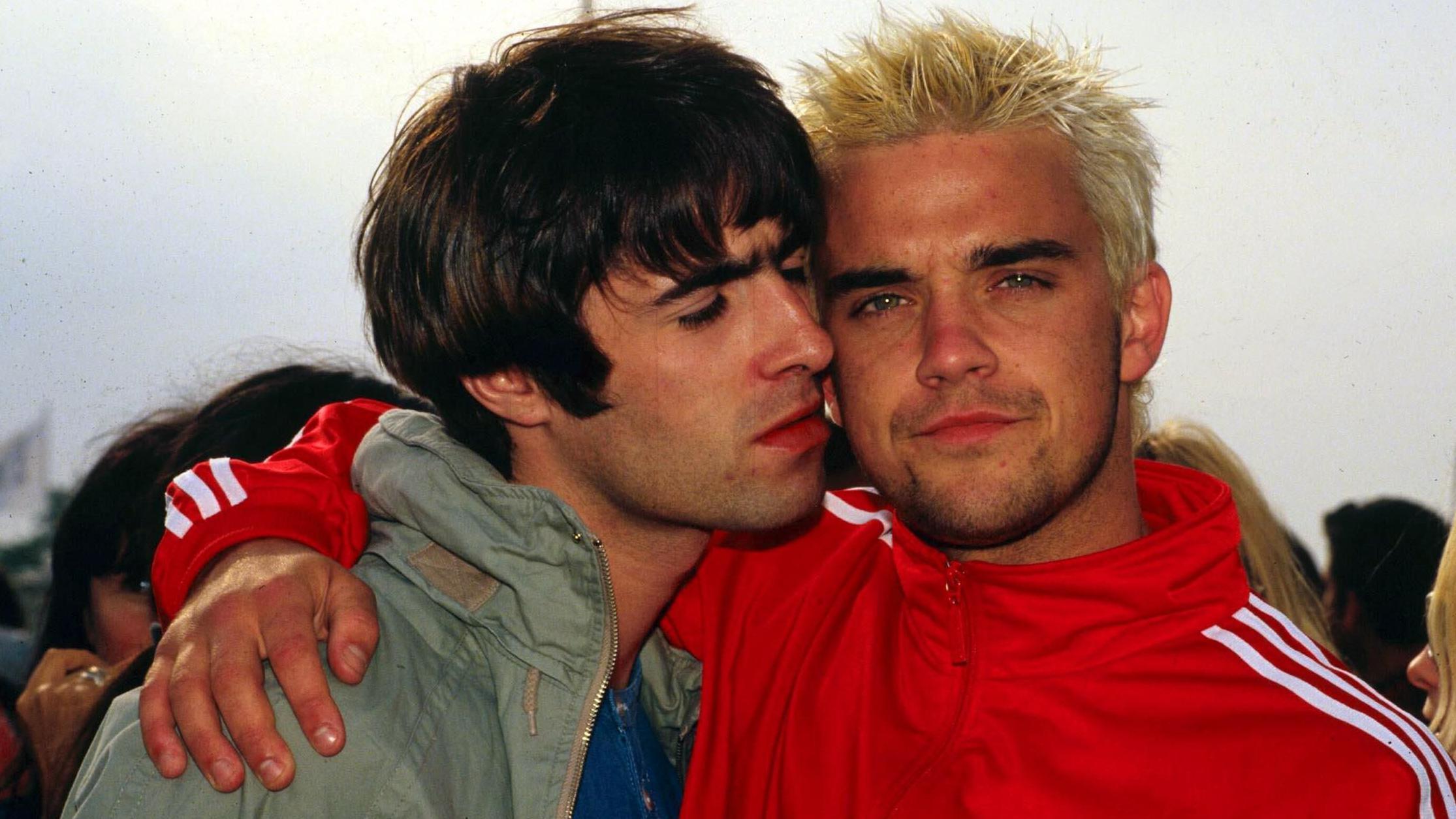 Robbie pictured with Liam Gallagher at Glastonbury in 1995, at the height of Britpop