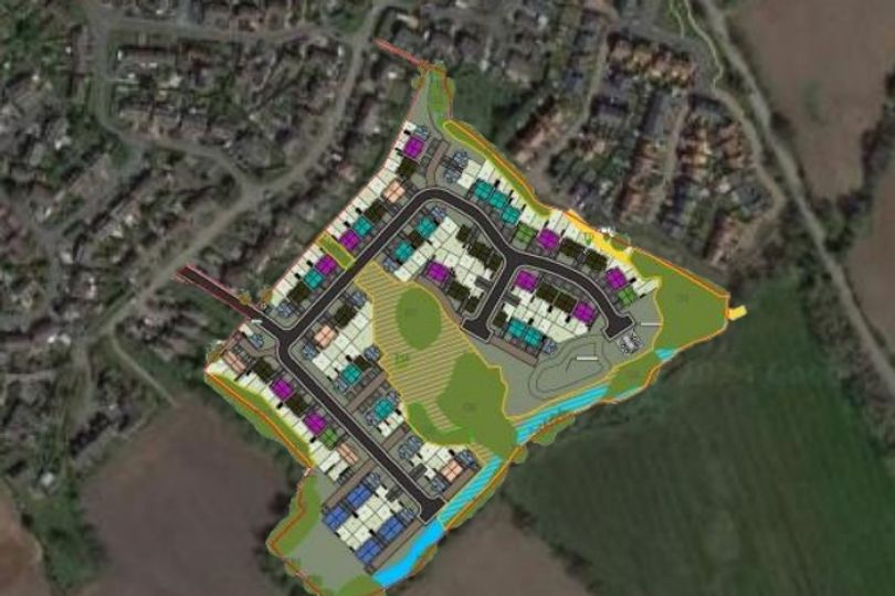 Public applaud as councillors defer plans for over 100 village homes