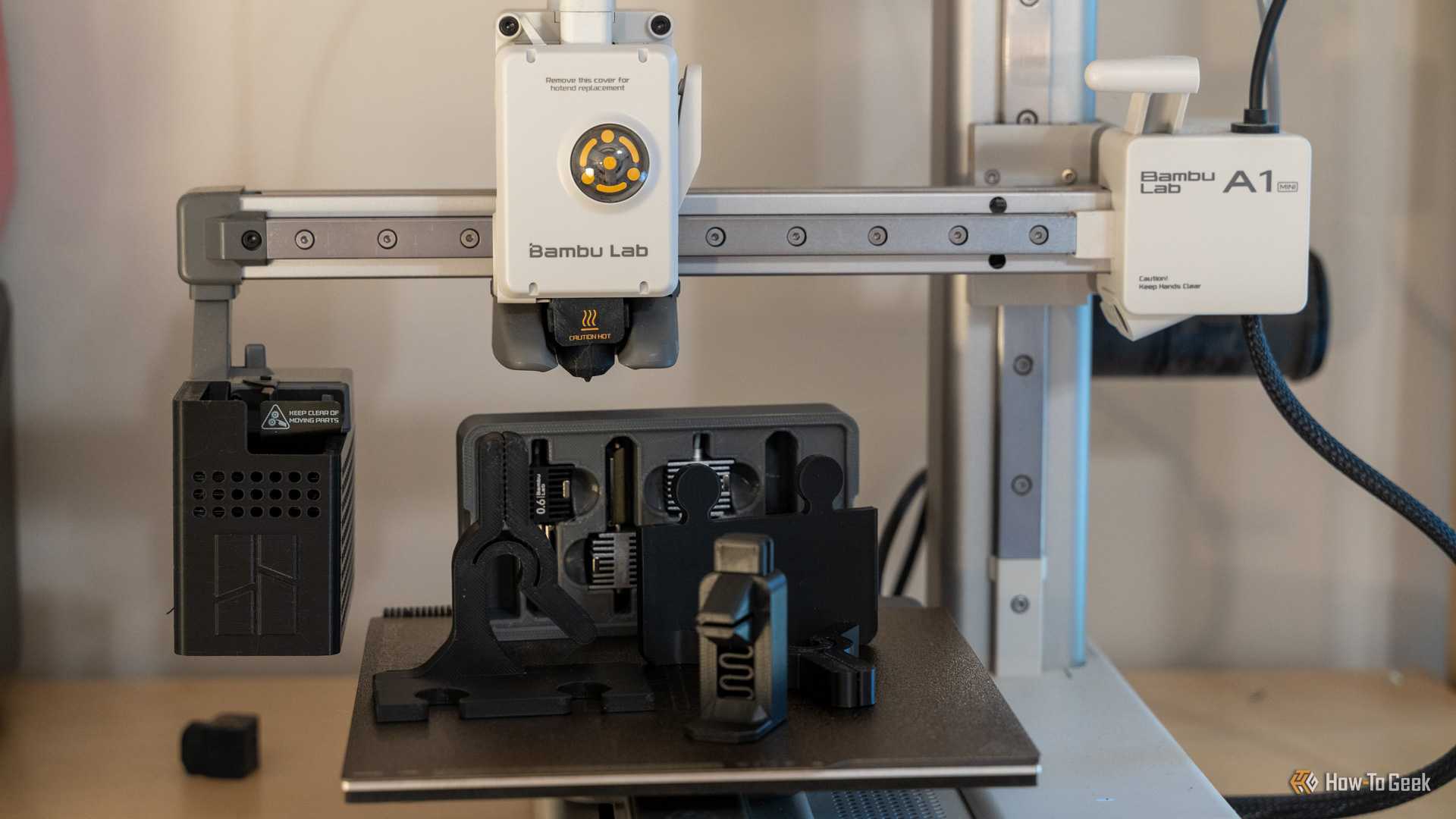 Bambu Labs A1 mini 3D printer with 3D printed components sitting on the build plate.