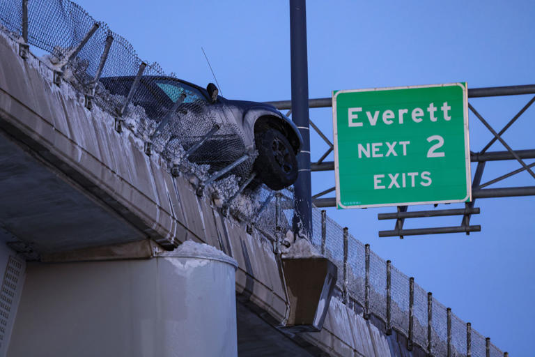 Truck dangling over barrier of I-93 near Zakim Bridge in Boston: Photos