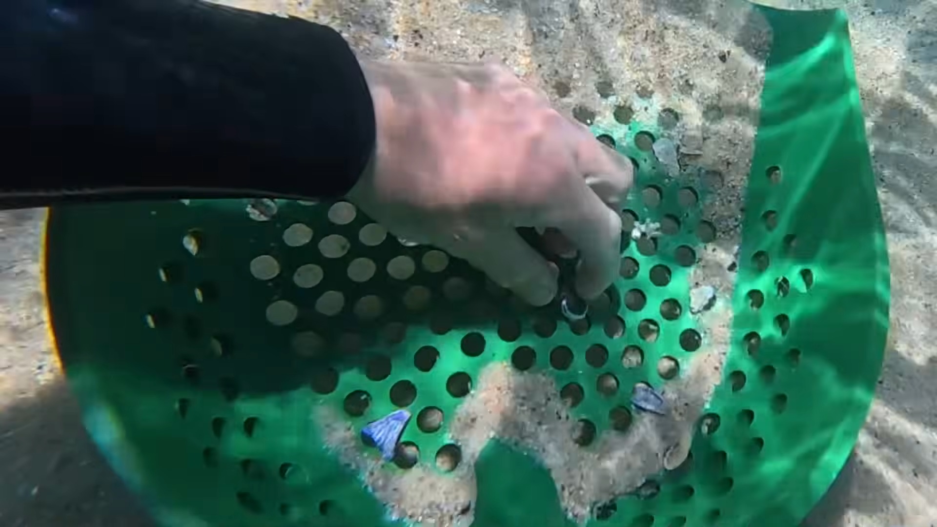 Busy beach sand can hold valuables lost by crowds