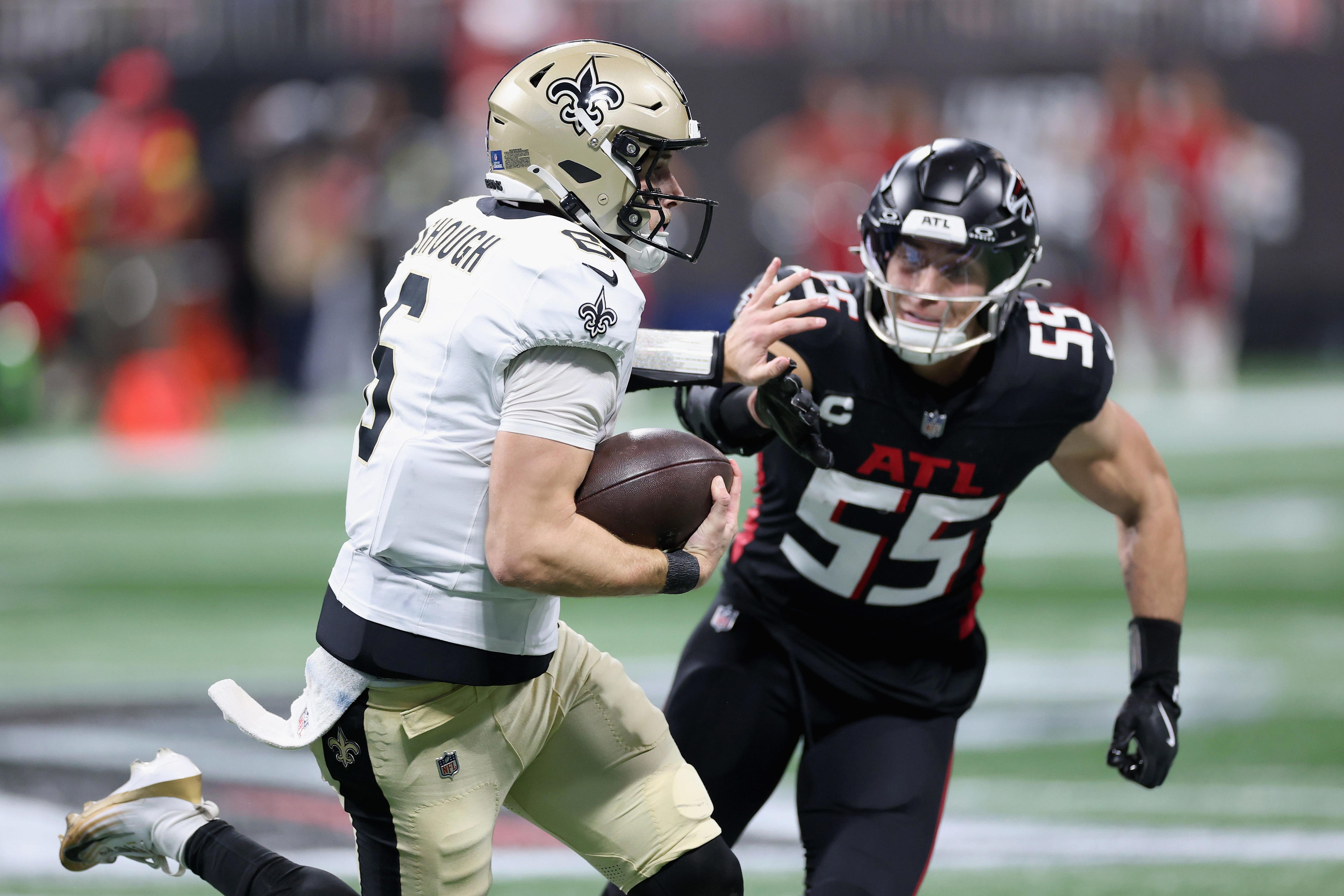 ATLANTA, GEORGIA - JANUARY 04: Tyler Shough #6 of the New Orleans Saints rushes against Kaden Elliss #55 of the Atlanta Falcons during the second half of the game at Mercedes-Benz Stadium on January 04, 2026 in Atlanta, Georgia. (Photo by Kevin C. Cox/Getty Images)