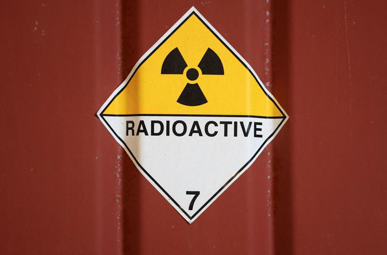 A radioactive sign is stuck to a container in the low-level waste vaults at the Dounreay nuclear site in Dounreay, Scotland, Britain November 25, 2025. REUTERS/Russell Cheyne