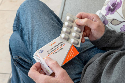 Man holding blister pack box packet of Atorvastatin statins. (Alamy/PA)