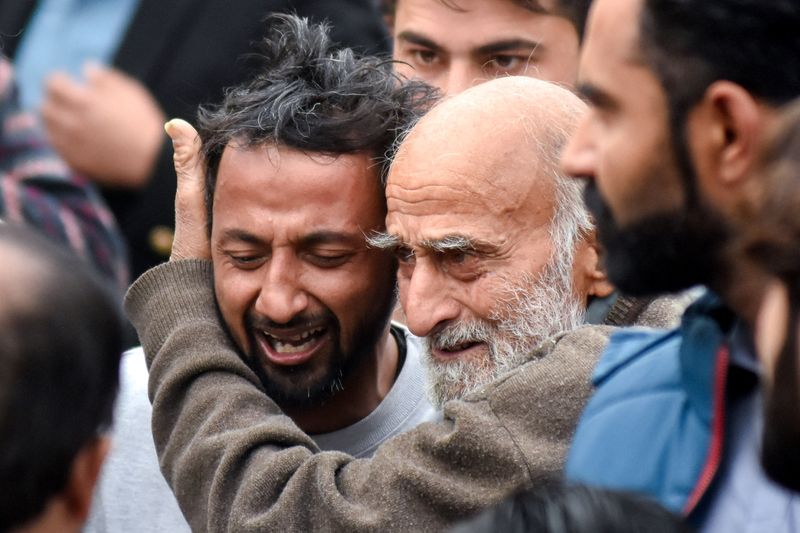 A man reacts while being comforted after a deadly explosion at a Shi'ite Muslim mosque in Islamabad, Pakistan, February 6, 2026. REUTERS/Waseem Khan