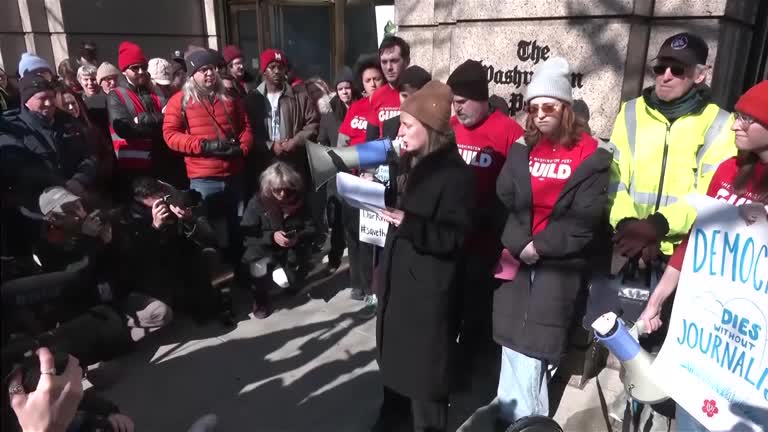 Protesters outside the Washington Post call layoffs 