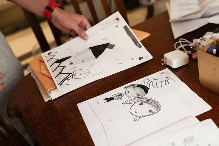 Yerson Vargas shows drawings made by his 6-year-old daughter, Maria, during their detention at Dilley. (Luisa Gonzalez / Reuters file)