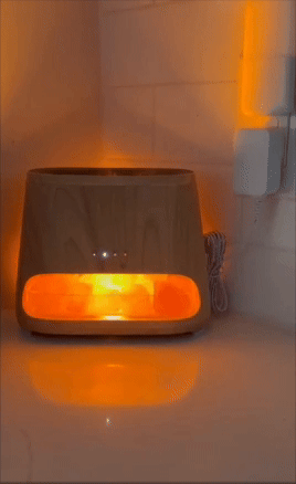 Wooden aromatherapy diffuser with a glowing light, placed on a countertop. It emits a warm, soothing ambiance, ideal for home relaxation