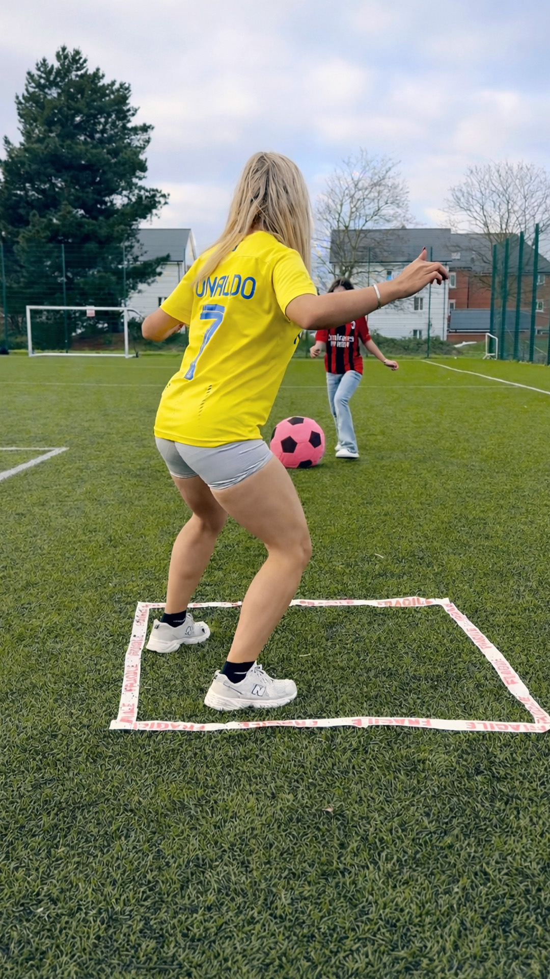 Professional football player tests her skills as the ball gets larger