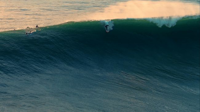 Surfers ride massive waves at Half Moon Bay