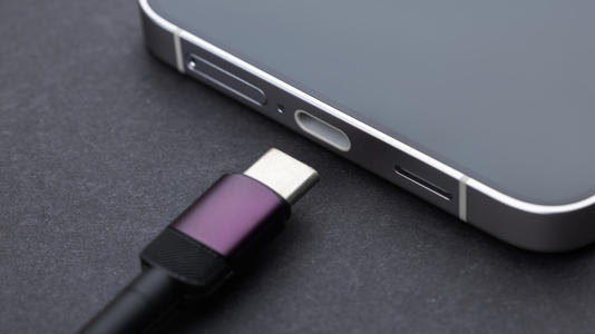 USB-C charging cable resting by plugin port on a smartphone